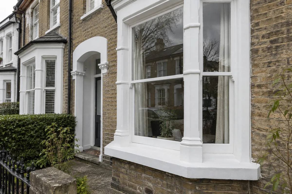 Window Cleaning in London 2 Clean ground-floor bay window and painted frame on a London townhouse.