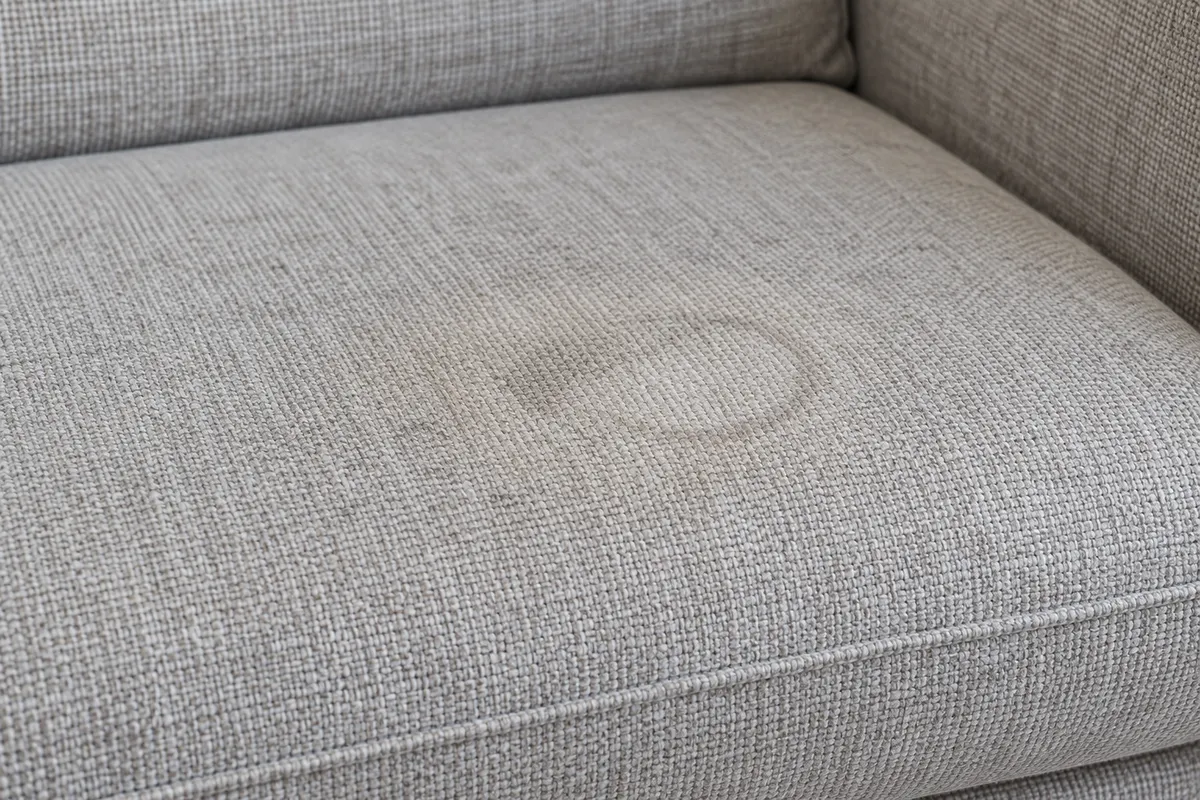 A close view of pale grey sofa fabric with a small outline and uneven shading.